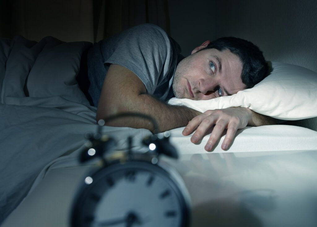stressed out male suffering from sleep disorder