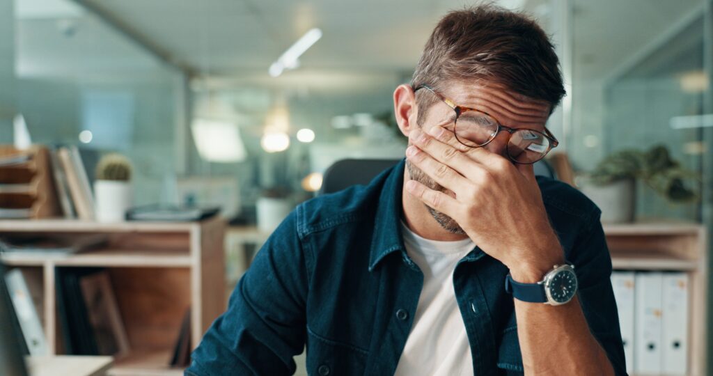 fatigues man rubbing his eyes