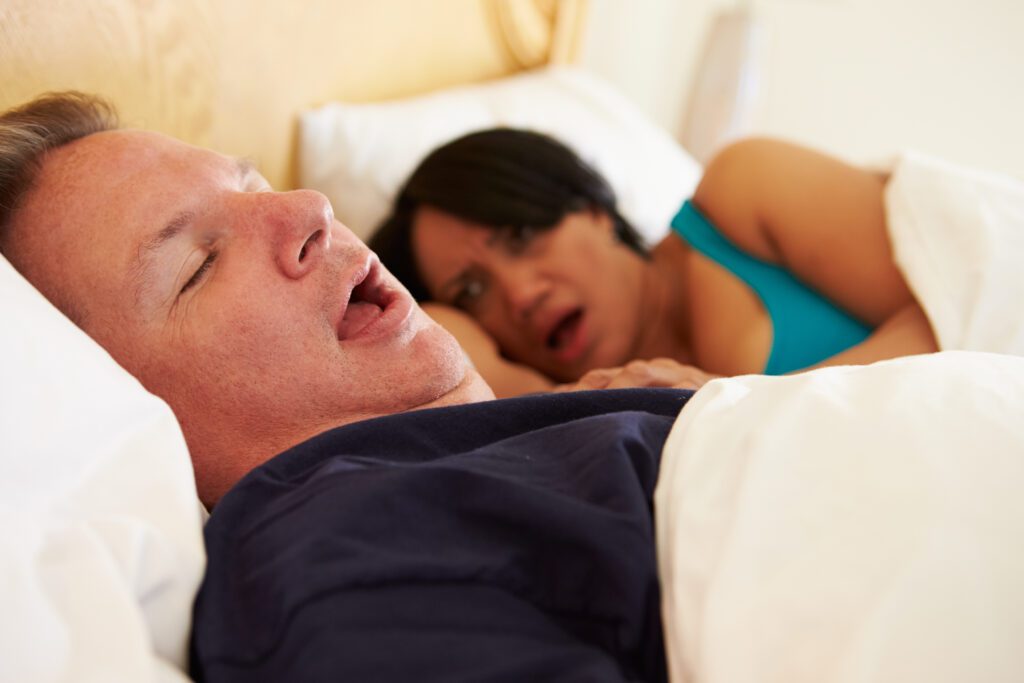 Couple Asleep In Bed With overweight Man Snoring