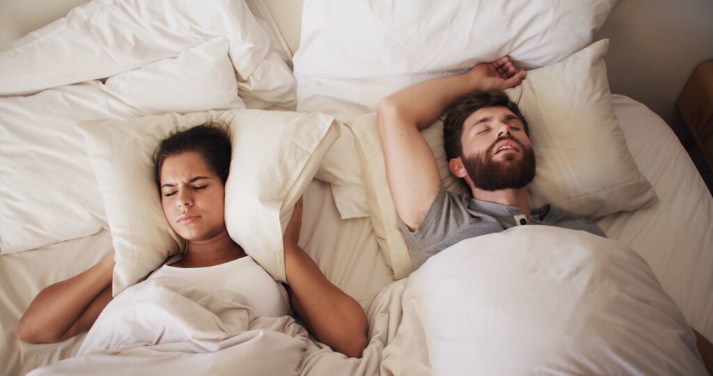Couple, bed and woman with man snoring, sleep apnea